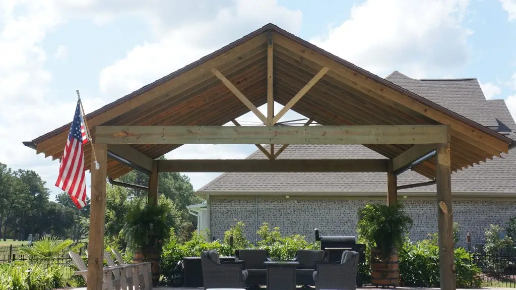 Covered pavilion with seating beside a swimming pool